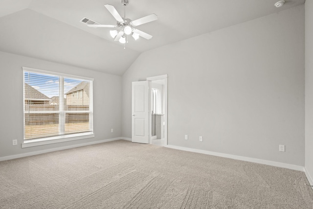 carpeted spare room with ceiling fan and vaulted ceiling