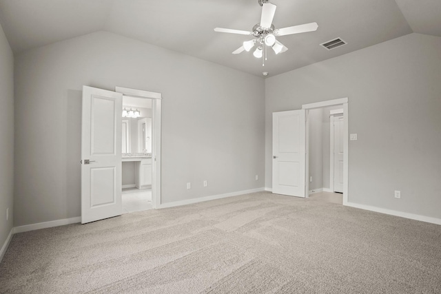 unfurnished bedroom with ensuite bathroom, lofted ceiling, light carpet, and ceiling fan