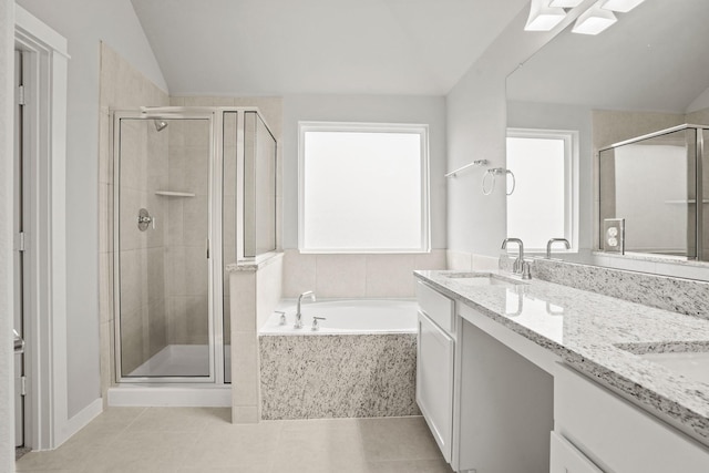 bathroom featuring vaulted ceiling, vanity, separate shower and tub, and tile patterned flooring