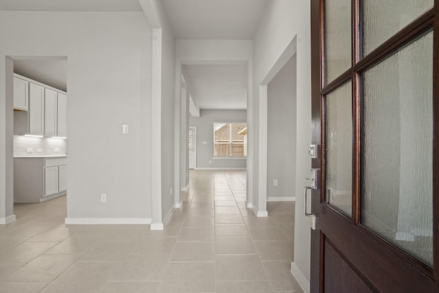 hall featuring light tile patterned floors