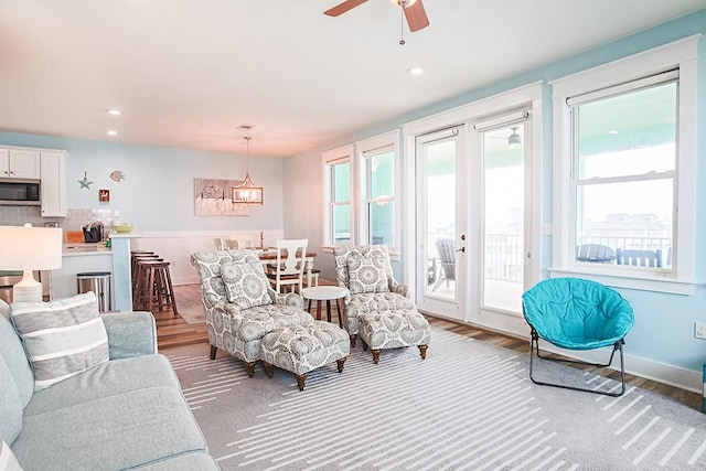 living room featuring ceiling fan and light hardwood / wood-style flooring