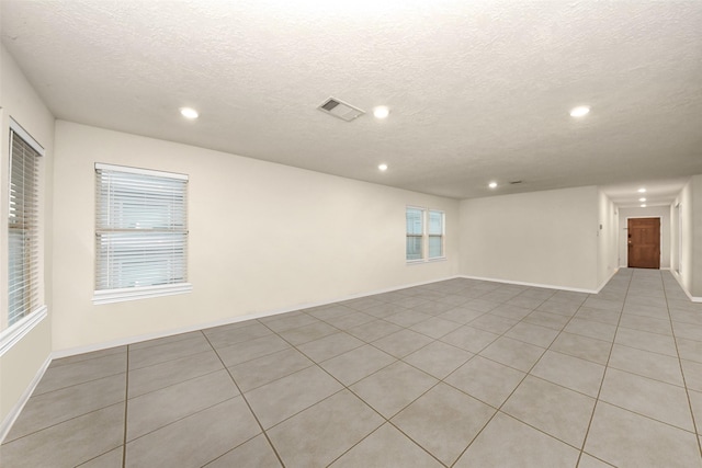 unfurnished room featuring a textured ceiling