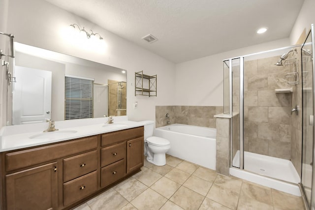 full bathroom featuring tile patterned flooring, vanity, a textured ceiling, independent shower and bath, and toilet