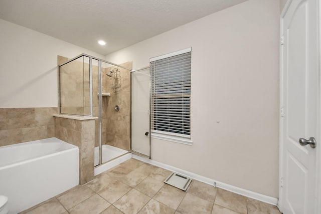 bathroom with tile patterned flooring and independent shower and bath