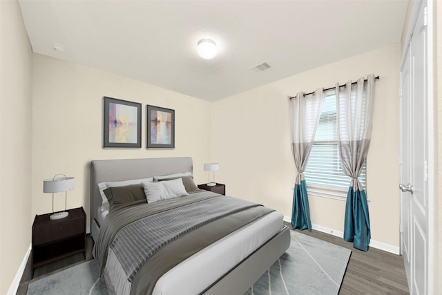 bedroom with dark wood-type flooring