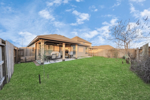 back of house with a lawn and a patio area