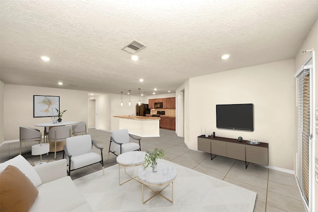 tiled living room with a textured ceiling