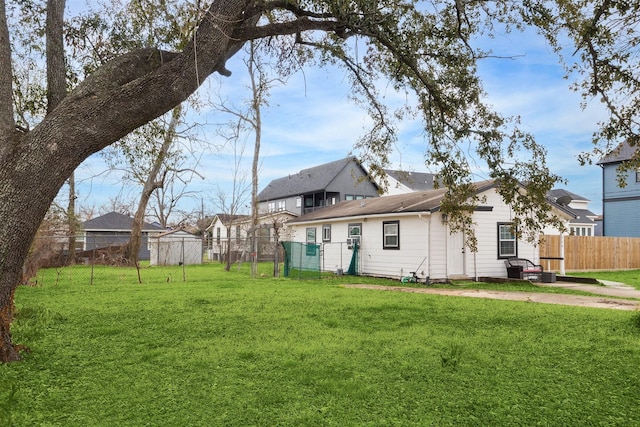 rear view of property with a lawn