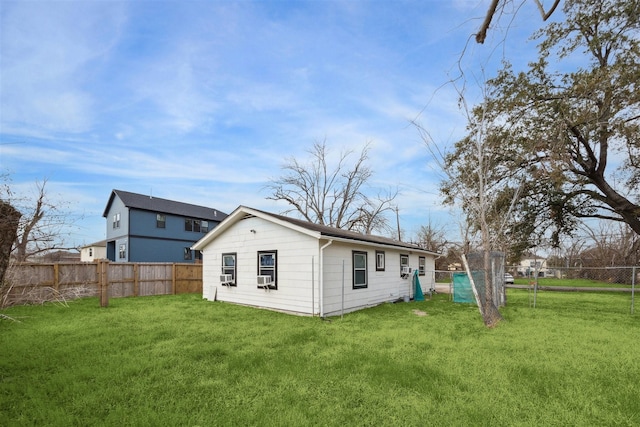 rear view of house with a lawn