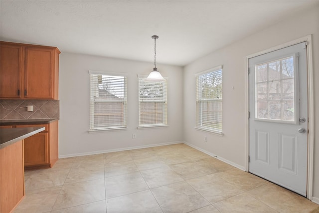 unfurnished dining area featuring light tile patterned flooring