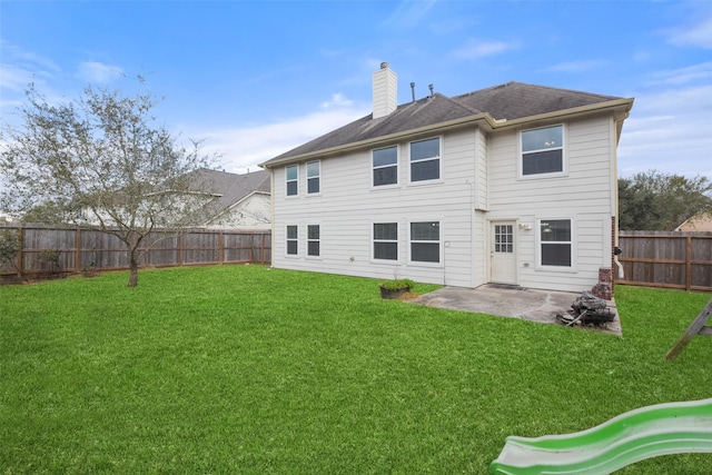 rear view of house featuring a patio and a lawn