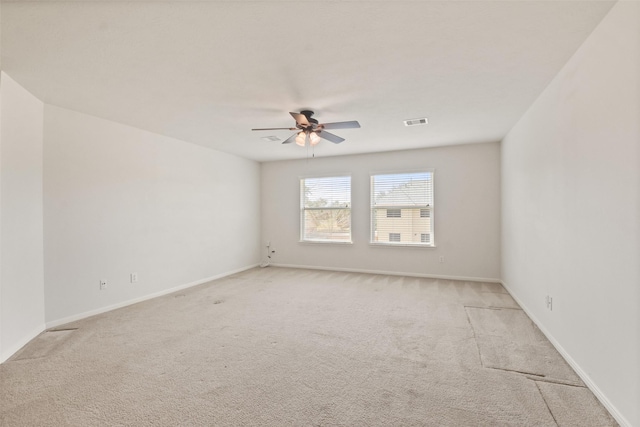 unfurnished room with ceiling fan and light colored carpet