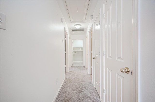 hallway with light colored carpet