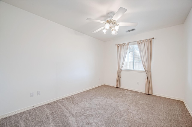 carpeted spare room featuring ceiling fan