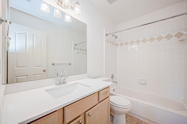 full bathroom featuring tiled shower / bath combo, vanity, tile patterned floors, and toilet