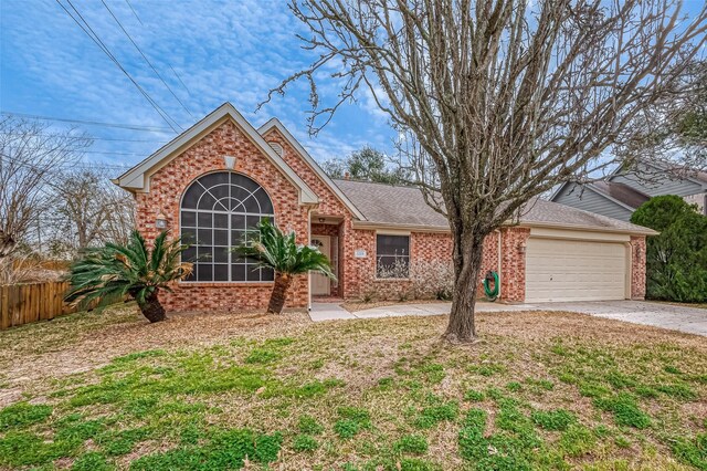 view of property with a garage and a front lawn