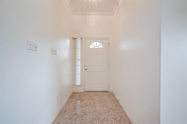 entryway featuring light tile patterned flooring and ornamental molding