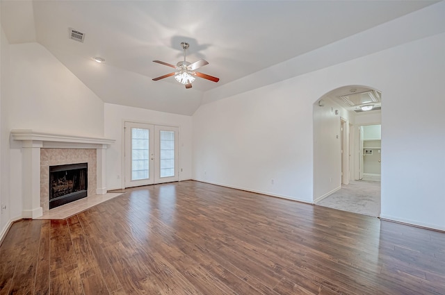 unfurnished living room featuring vaulted ceiling, hardwood / wood-style floors, ceiling fan, and french doors