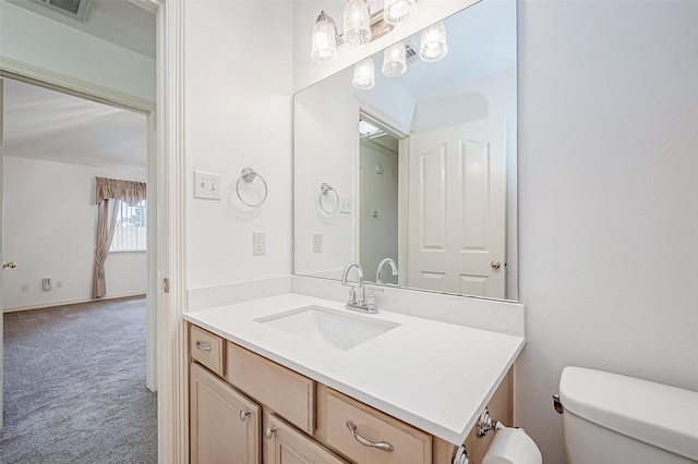 bathroom featuring vanity and toilet