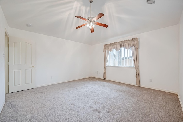 carpeted empty room featuring ceiling fan and lofted ceiling