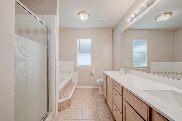 full bathroom featuring plus walk in shower, vanity, tile patterned floors, and toilet