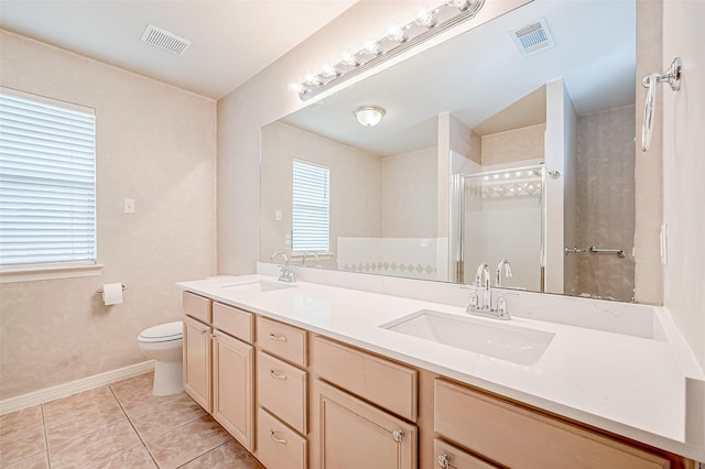 bathroom with vanity, toilet, a shower with shower door, and tile patterned flooring