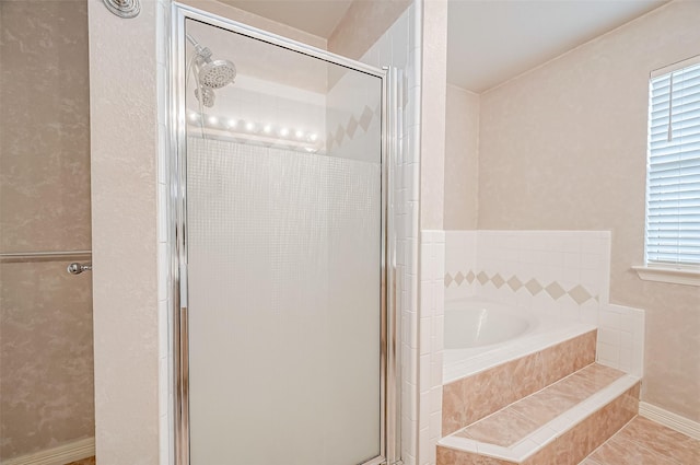 bathroom featuring shower with separate bathtub and tile patterned flooring