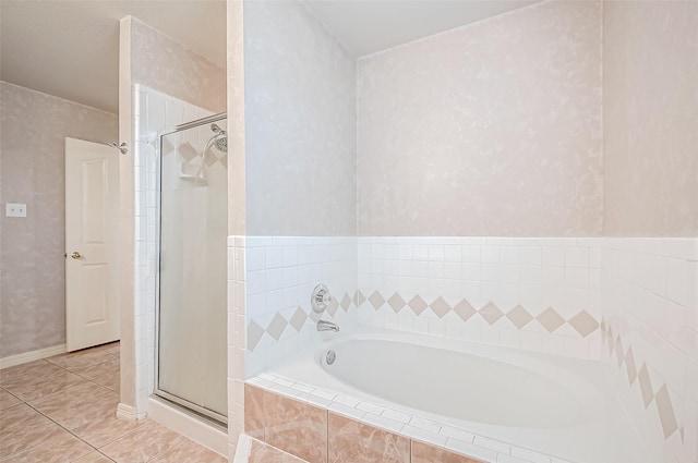 bathroom with plus walk in shower and tile patterned flooring