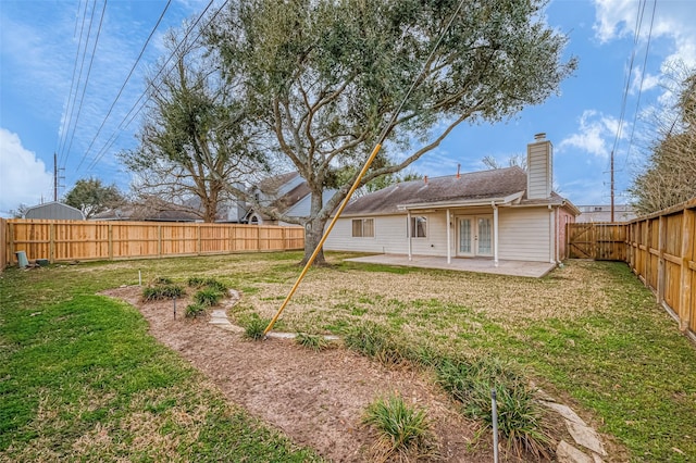 rear view of house with a patio area and a lawn