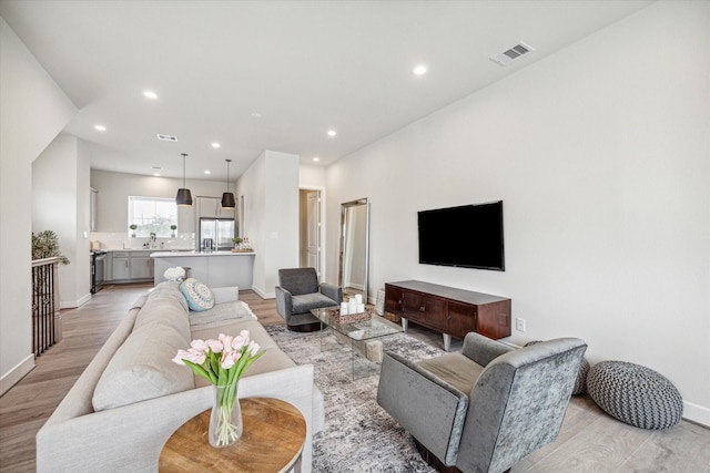 living room with light hardwood / wood-style flooring