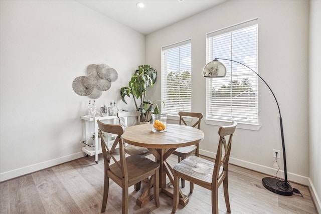 dining space with light hardwood / wood-style floors