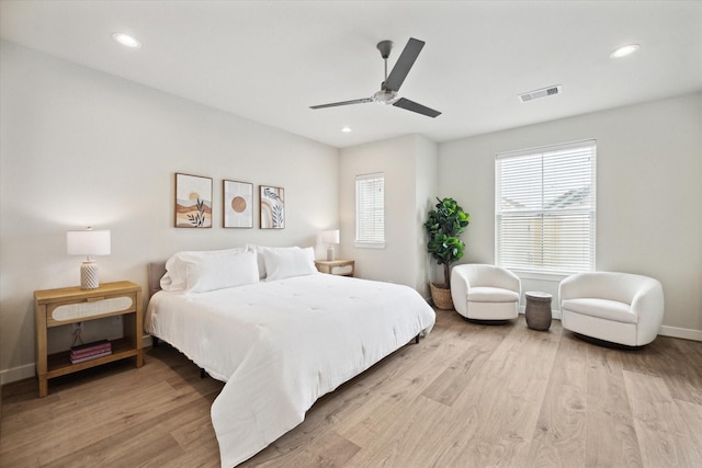 bedroom featuring multiple windows, ceiling fan, and light wood-type flooring