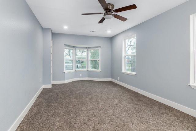 carpeted empty room featuring ceiling fan