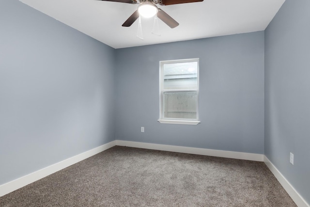 spare room featuring ceiling fan and carpet