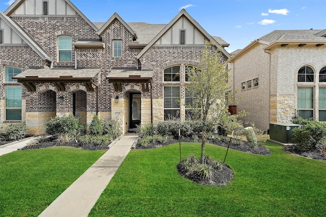 view of front of property with a front yard and central air condition unit