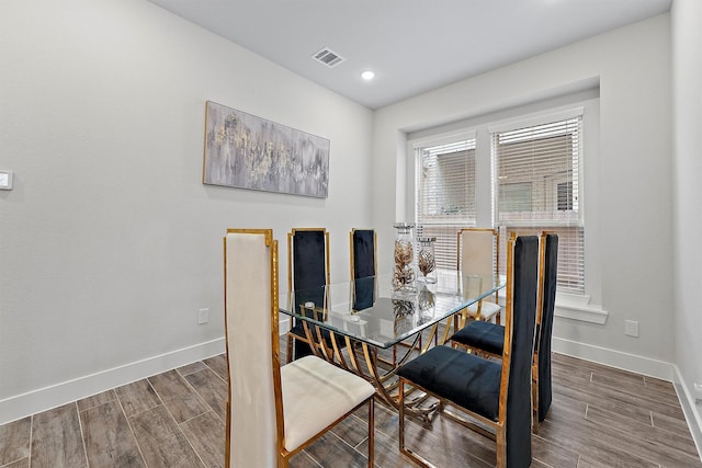 dining space with wood-type flooring