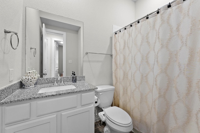 bathroom featuring vanity and toilet