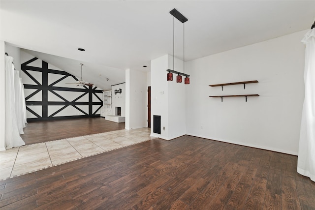 interior space with vaulted ceiling, ceiling fan, and light hardwood / wood-style floors