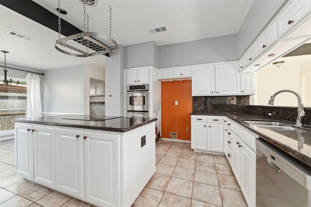 kitchen featuring white cabinetry, stainless steel appliances, sink, and dark stone countertops