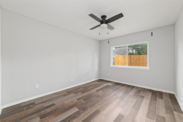 spare room featuring dark hardwood / wood-style flooring and ceiling fan