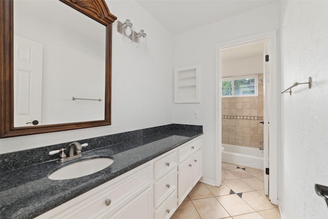 full bathroom featuring vanity, tiled shower / bath combo, tile patterned floors, and toilet