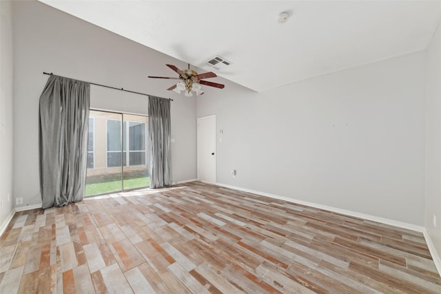 empty room with ceiling fan, lofted ceiling, and light hardwood / wood-style floors