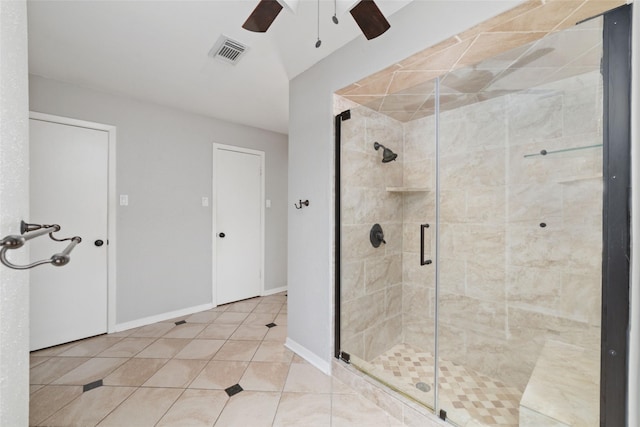 bathroom with tile patterned flooring, ceiling fan, and walk in shower