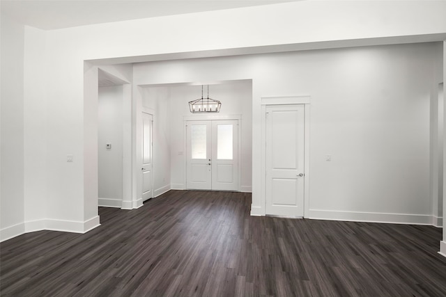 entryway with french doors, dark hardwood / wood-style flooring, and a notable chandelier