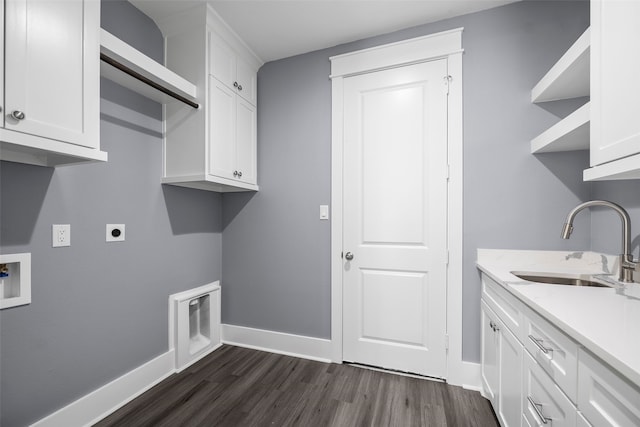 laundry area with sink, cabinets, dark hardwood / wood-style floors, hookup for a washing machine, and hookup for an electric dryer