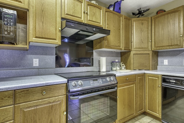 kitchen with wall oven, backsplash, stainless steel electric range, and light tile patterned flooring