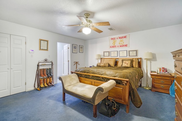 bedroom with a textured ceiling, carpet floors, a closet, and ceiling fan