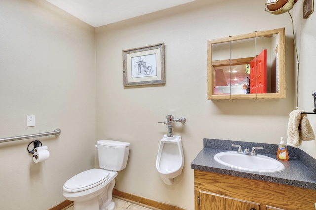 bathroom featuring tile patterned flooring, vanity, and toilet