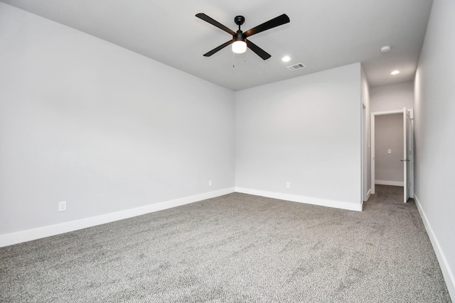 carpeted spare room featuring ceiling fan