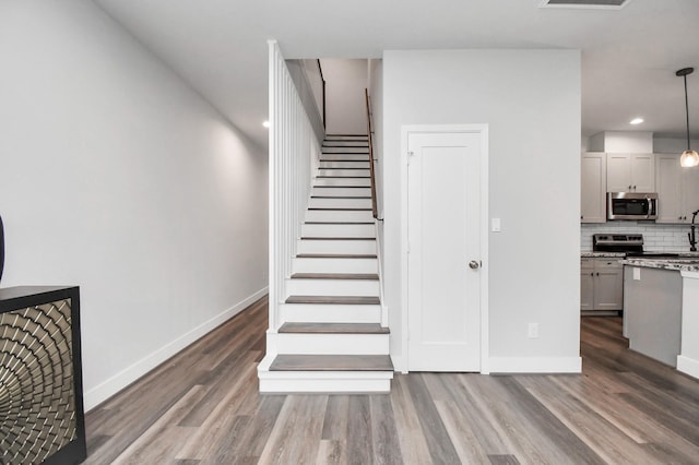 staircase featuring hardwood / wood-style floors